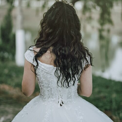 The back of a bride in a wedding dress.